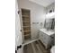 Stylish bathroom with a modern vanity, sleek lighting, and convenient shelving at 2006 Cramerton Village Dr # 31-D, Cramerton, NC 28032