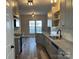 Stylish kitchen featuring gray cabinets, granite countertops, and stainless steel appliances at 2006 Cramerton Village Dr # 31-D, Cramerton, NC 28032