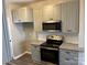 Kitchen with stainless steel appliances, granite countertops, and gray cabinets at 2006 Cramerton Village Dr # 31-D, Cramerton, NC 28032