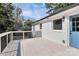 Exterior view of home with a spacious back deck and a blue entry door at 2038 Sandhurst Dr, Charlotte, NC 28205