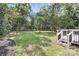 Lush backyard offering plenty of green space, mature trees, and a small deck at 2038 Sandhurst Dr, Charlotte, NC 28205