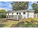 Exterior view of the back of the house featuring a small deck and lush greenery at 2038 Sandhurst Dr, Charlotte, NC 28205