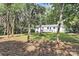 Expansive backyard with mature trees and a deck, perfect for outdoor entertaining and relaxation at 2038 Sandhurst Dr, Charlotte, NC 28205