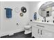 Modern bathroom featuring a sleek vanity, black fixtures, decorative wall art, and stylish black tile flooring at 2038 Sandhurst Dr, Charlotte, NC 28205