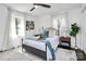 Stylishly furnished bedroom featuring a comfortable bed with soft textures, accent pillows, and ample natural light at 2038 Sandhurst Dr, Charlotte, NC 28205