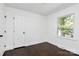 A room with dark hardwood flooring, one double-hung window, and white walls at 2038 Sandhurst Dr, Charlotte, NC 28205