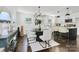Bright dining area adjacent to the kitchen, featuring a modern chandelier and seating for four guests at 2038 Sandhurst Dr, Charlotte, NC 28205