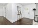 Welcoming foyer with hardwood floors, a modern mirror, and natural light from a glass-paneled front door at 2038 Sandhurst Dr, Charlotte, NC 28205