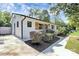 Charming single-story home with white siding, black trim, a well-manicured lawn and beautiful plantings at 2038 Sandhurst Dr, Charlotte, NC 28205