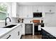Updated kitchen boasts white countertops, stainless appliances, and modern fixtures at 2038 Sandhurst Dr, Charlotte, NC 28205