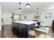 Open concept kitchen features island seating, quartz countertops, and modern lighting at 2038 Sandhurst Dr, Charlotte, NC 28205
