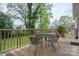 Outdoor deck area with metal table and chairs overlooking the spacious backyard, ideal for entertaining at 205 Gamble Ave, Bessemer City, NC 28016