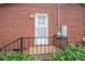Brick exterior of back entrance featuring a sturdy metal railing at 205 Gamble Ave, Bessemer City, NC 28016