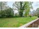 A lush backyard and mature trees, seen from the back deck. Great space for outdoor activities at 205 Gamble Ave, Bessemer City, NC 28016