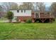 Exterior view of a brick and white home with a wooden deck overlooking the backyard at 205 Gamble Ave, Bessemer City, NC 28016