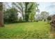 Expansive backyard with lush lawn and mature trees, providing ample space for outdoor activities and relaxation at 205 Gamble Ave, Bessemer City, NC 28016
