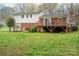 Exterior view of a brick and white home with a wooden deck and lush backyard at 205 Gamble Ave, Bessemer City, NC 28016
