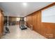 Spacious finished basement with paneled walls, tile flooring, and a treadmill at 205 Gamble Ave, Bessemer City, NC 28016