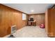 Finished basement area featuring paneled walls, a desk, and a vintage heater at 205 Gamble Ave, Bessemer City, NC 28016