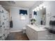 Bathroom with white vanity, large mirror, and shower with patterned curtain at 205 Gamble Ave, Bessemer City, NC 28016