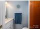Close up of a clean half-bath with vanity, sink, and decorative accents at 205 Gamble Ave, Bessemer City, NC 28016