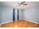 Bedroom with hardwood floors, blue walls, and a ceiling fan with lighting at 205 Gamble Ave, Bessemer City, NC 28016