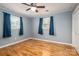 Bright bedroom with hardwood floors, blue walls, ceiling fan and natural light at 205 Gamble Ave, Bessemer City, NC 28016