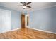 Bedroom with hardwood floors, light blue walls, a ceiling fan, and closet at 205 Gamble Ave, Bessemer City, NC 28016
