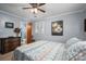 Bedroom with blue walls, carpet, wood furniture, and ensuite bathroom entrance at 205 Gamble Ave, Bessemer City, NC 28016