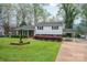 Traditional home featuring manicured landscaping, a brick facade, and convenient carport at 205 Gamble Ave, Bessemer City, NC 28016