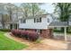 Exterior view showcasing the home's siding, brick accents, and convenient carport at 205 Gamble Ave, Bessemer City, NC 28016