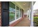 Covered porch with white columns and large windows, offering a charming curb appeal at 205 Gamble Ave, Bessemer City, NC 28016