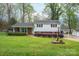 Traditional home featuring manicured landscaping, a brick facade, and convenient carport at 205 Gamble Ave, Bessemer City, NC 28016