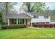 Traditional home featuring manicured landscaping, a brick facade, and white siding at 205 Gamble Ave, Bessemer City, NC 28016