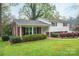 Traditional home featuring manicured landscaping, a brick facade, and white siding at 205 Gamble Ave, Bessemer City, NC 28016