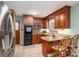 Charming kitchen with rich wood cabinetry and breakfast bar seating at 205 Gamble Ave, Bessemer City, NC 28016