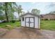 Charming backyard shed with double doors and neutral color scheme at 205 Gamble Ave, Bessemer City, NC 28016