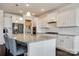 Bright, open kitchen with a large granite island, white cabinetry, and stainless steel appliances, perfect for entertaining at 2052 Donaldson St, Indian Land, SC 29707
