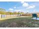 Large backyard with a wooden fence, grassy area, and trampoline; ideal for outdoor activities at 213 Morton St, Shelby, NC 28152