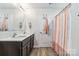 Bathroom featuring a double sink vanity, a shower and towel racks at 213 Morton St, Shelby, NC 28152