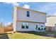 Backyard of a two-story home with vinyl siding and a patio area, fenced for added privacy at 213 Morton St, Shelby, NC 28152