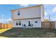 Two-story home exterior with a patio and fenced backyard, set in a well-maintained lawn at 213 Morton St, Shelby, NC 28152