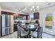 Bright kitchen features stainless steel appliances, dark cabinetry, granite countertops, and a view to the backyard at 213 Morton St, Shelby, NC 28152