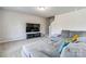 Cozy living room with a comfortable gray sectional sofa, TV, and staircase at 213 Morton St, Shelby, NC 28152