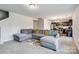 Bright living room featuring a gray sectional sofa and an open view to the kitchen at 213 Morton St, Shelby, NC 28152