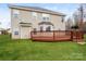 Spacious backyard features a stained wooden deck, a lush lawn, and a two-story home at 240 Bluffton Rd, Mooresville, NC 28115