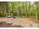 Charming backyard retreat with a swing and fire pit, nestled among mature trees at 2470 Highway 557 Rd, Clover, SC 29710