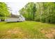 Spacious backyard with healthy green grass and trees in the background at 2470 Highway 557 Rd, Clover, SC 29710