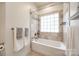 Nicely tiled tub and shower, featuring a rainfall shower head and glass block window at 2470 Highway 557 Rd, Clover, SC 29710