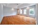 Spacious bedroom featuring hardwood floors, tray ceiling, and abundant natural light from three large windows at 2470 Highway 557 Rd, Clover, SC 29710